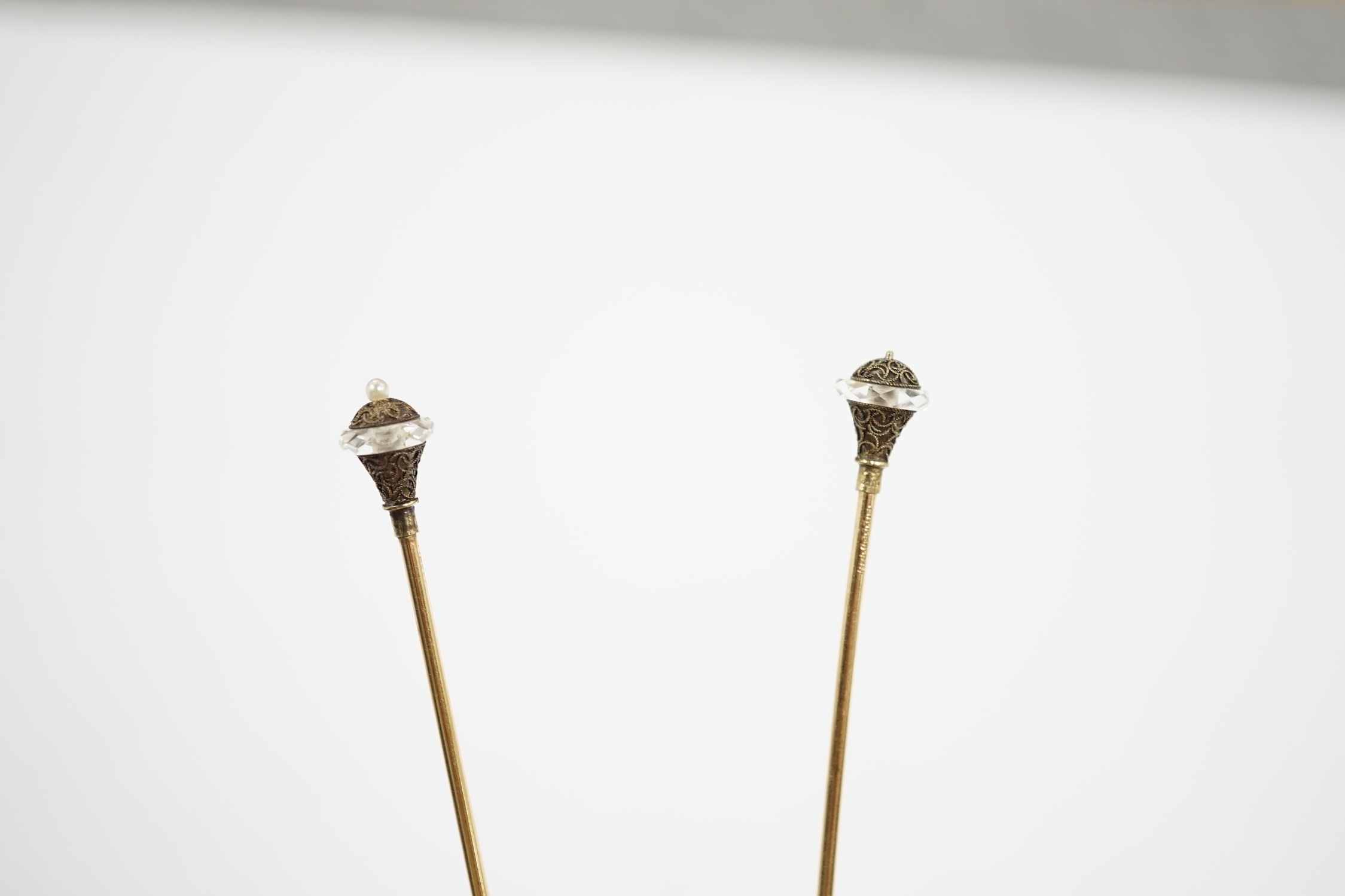 A pair of seed pearl set 'filled pin' hatpins, one a.f. 16cm.